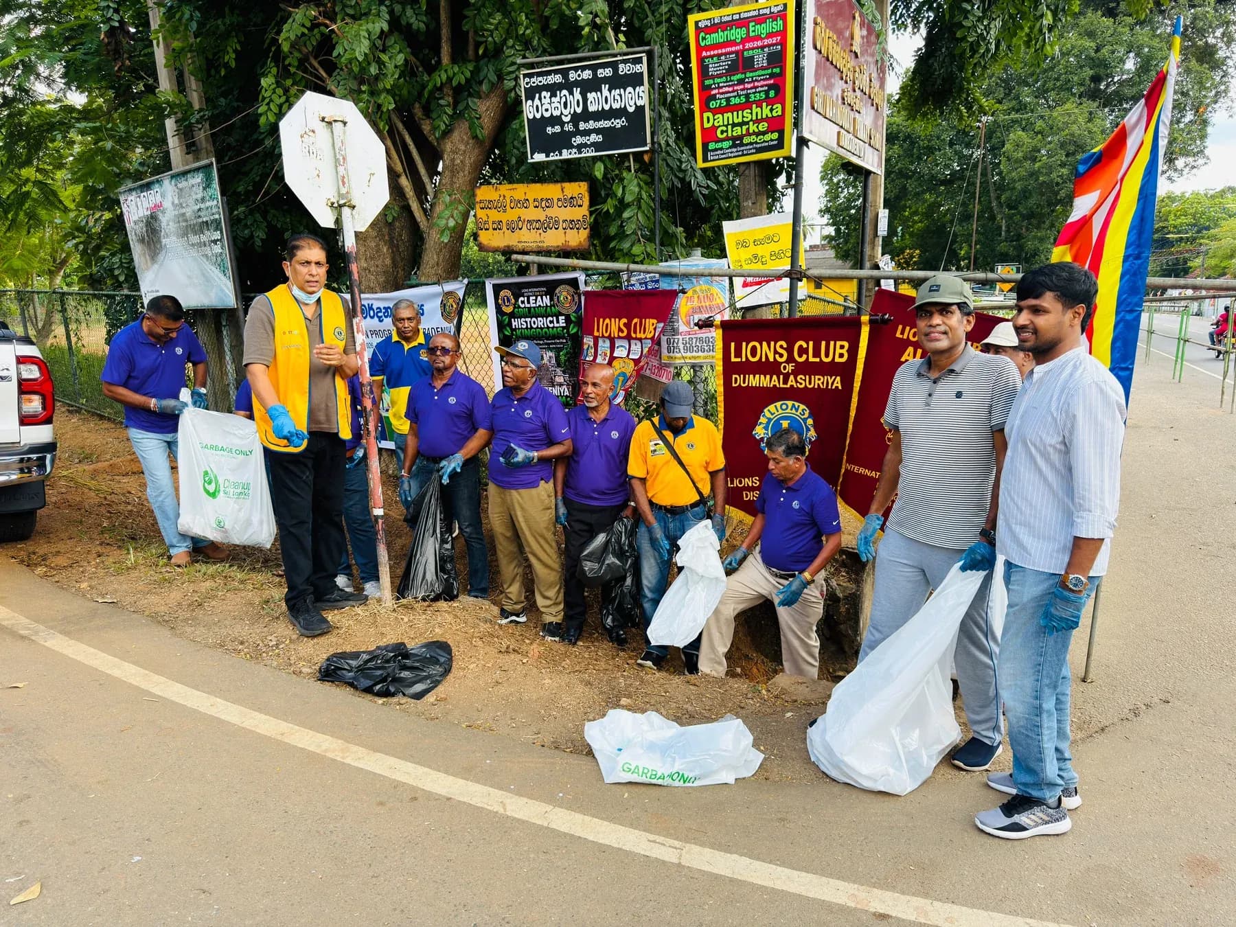 Members and volunteers gathered with club banners and collected waste.